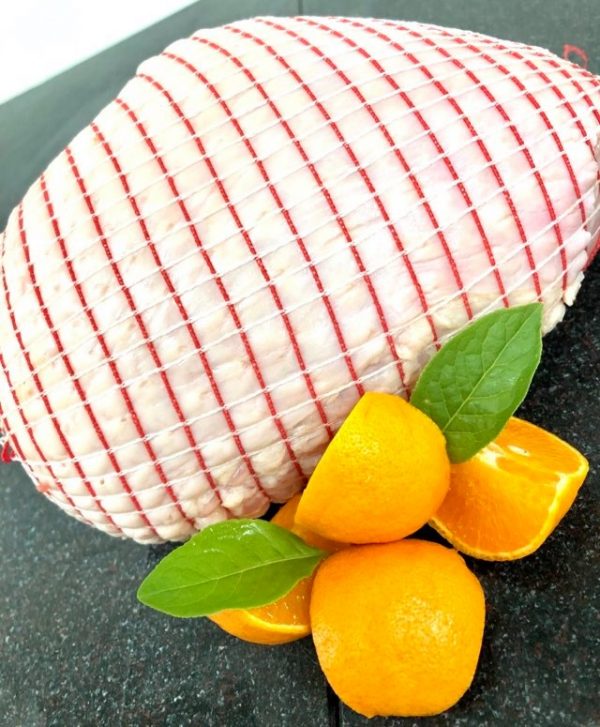 Trussed turkey breast joint garnished with orange quarters